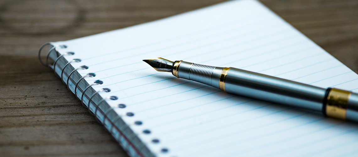 calligraphy pen on a notepad