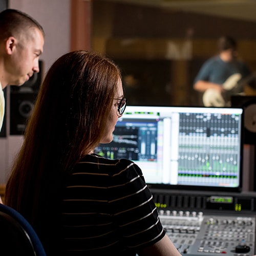 uma music students working in uma recording studio