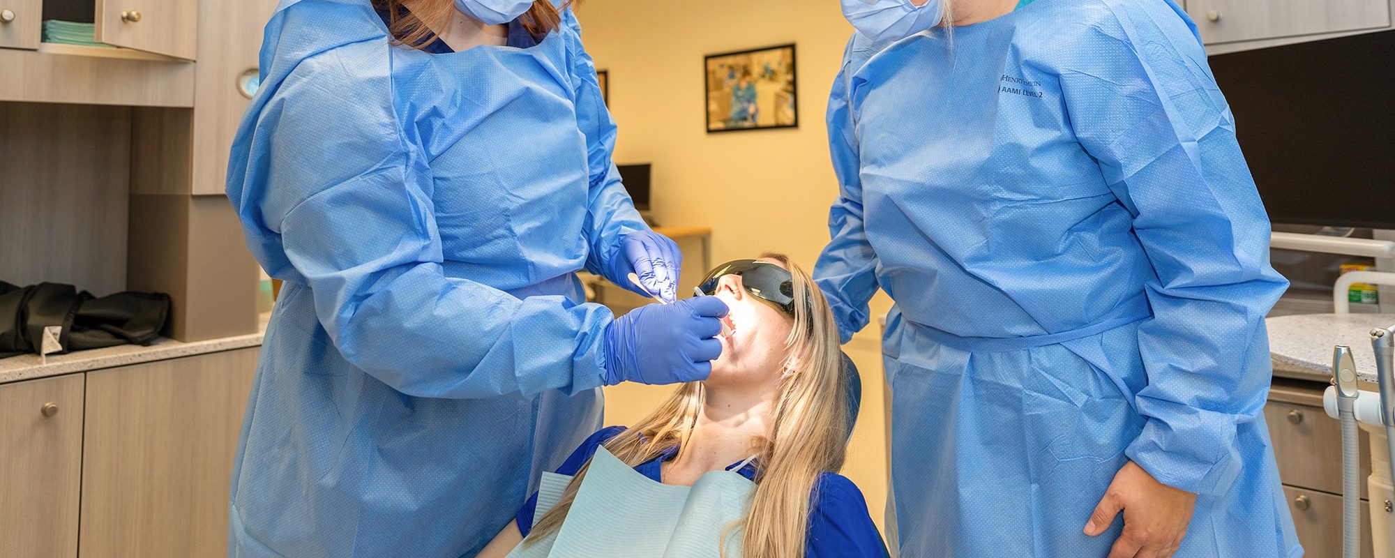 uma dental students examining patient uma dental students examining patient