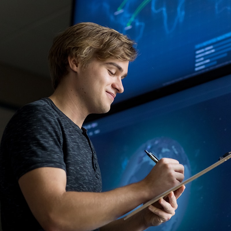 uma cybersecurity student taking notes