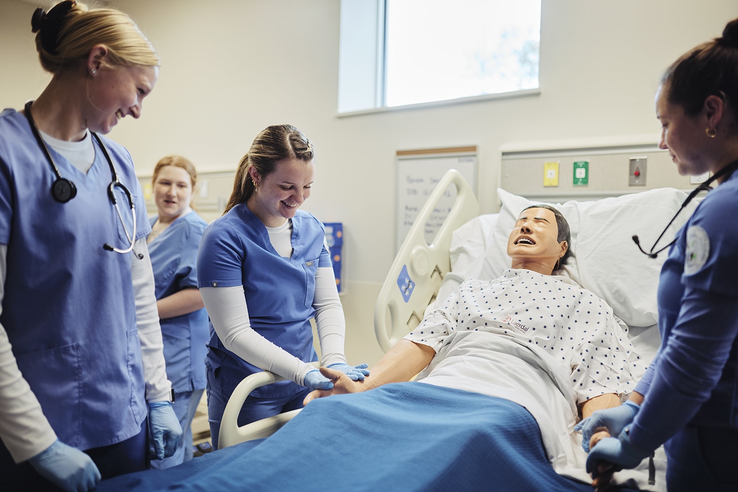 uma students engaging with nursing sim