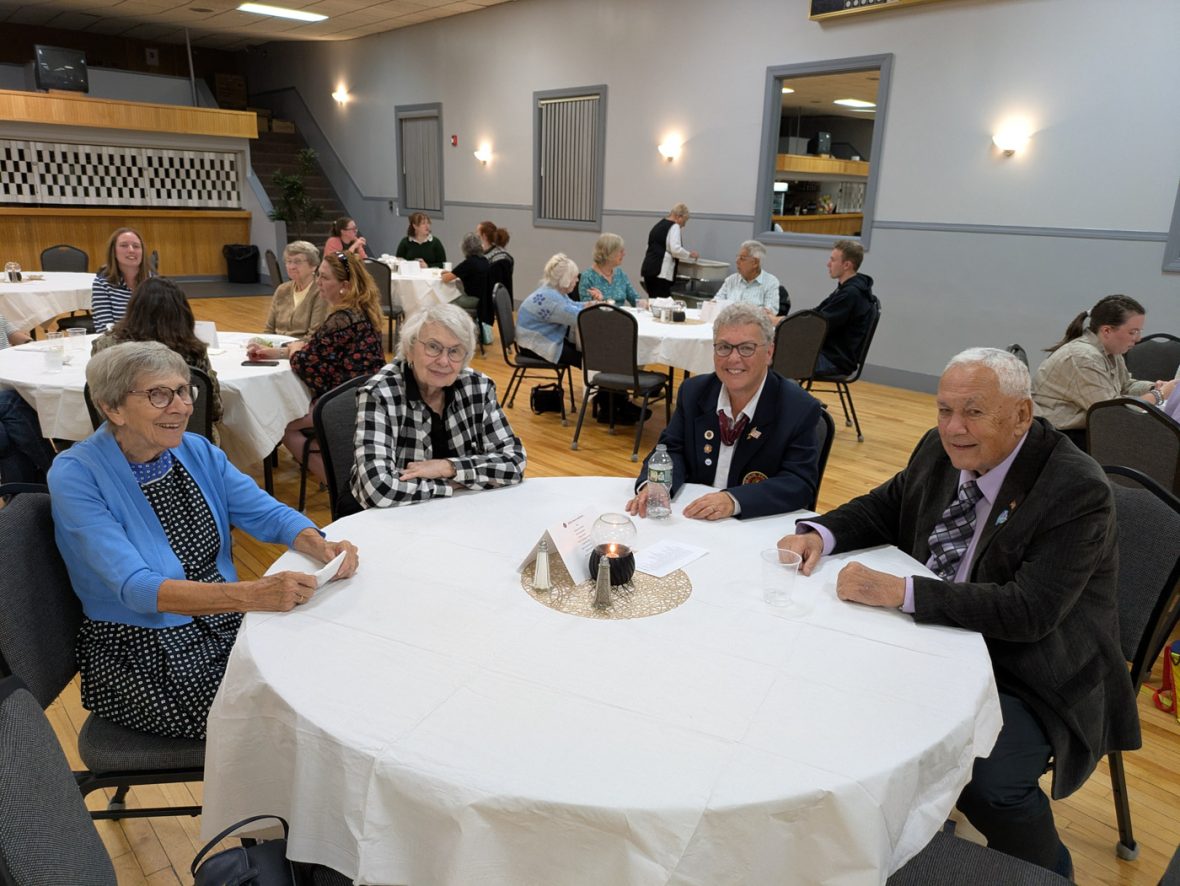 attendees seated around a banquet table