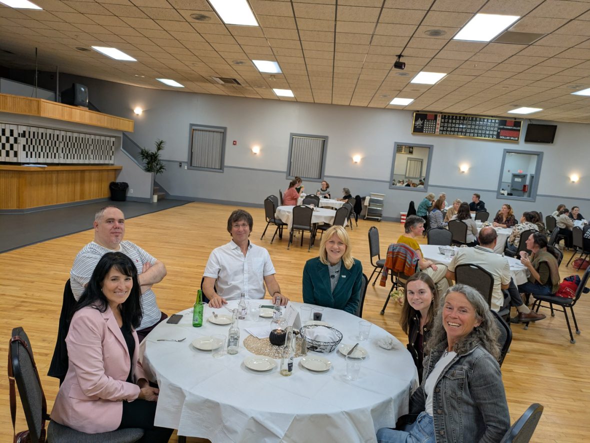 attendees seated around a banquet table