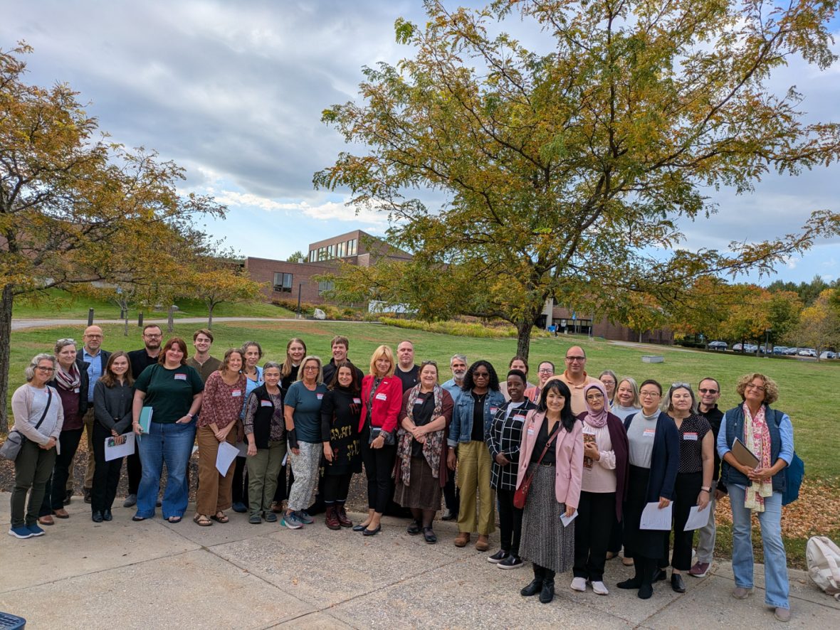 Group photo of French immersion program participants gathered outdoors in front of a campus building.