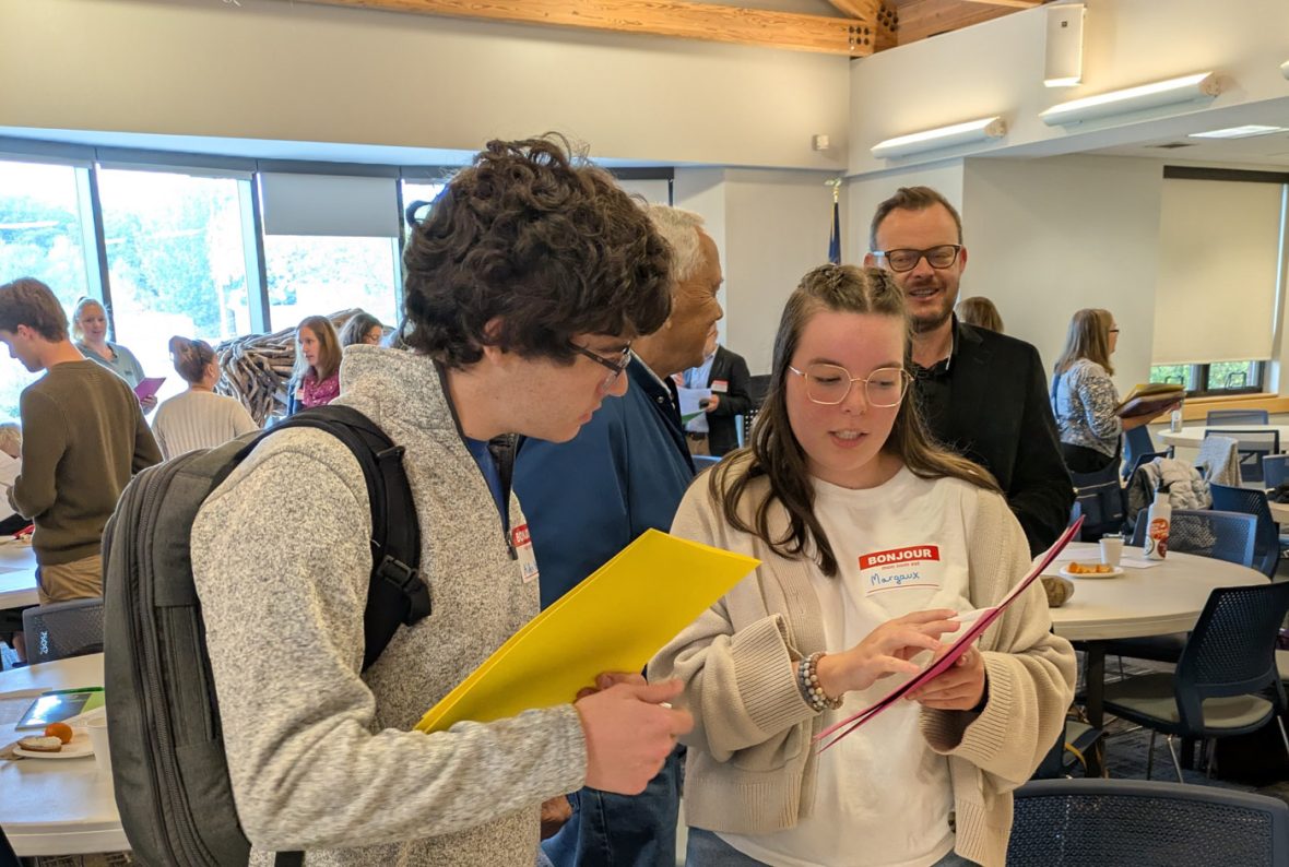 Participants review materials together during a French immersion program activity.