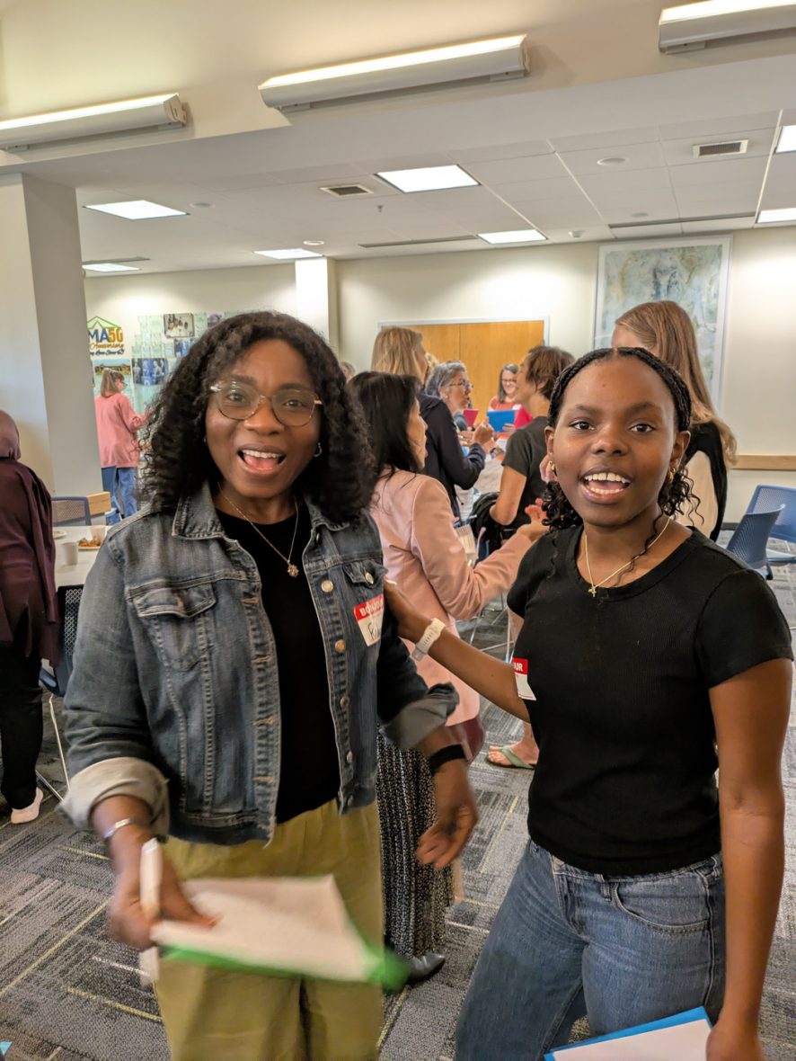 Two attendees posing together for a photo
