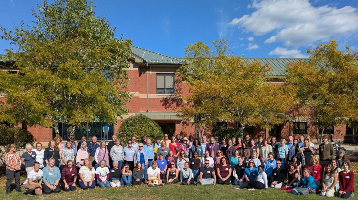 Group photo of French immersion program participants gathered outdoors in front of a campus building.