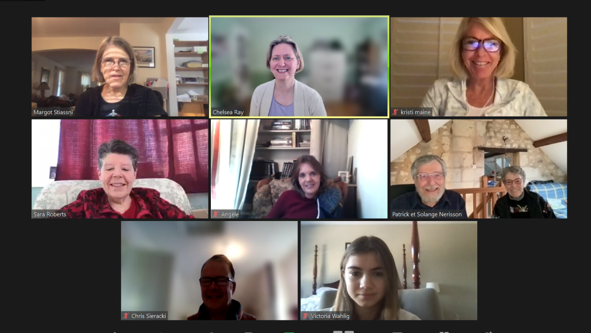 Screenshot of a Zoom meeting showing eight participants in gallery view, including one pair sharing a screen, with most smiling from their homes.