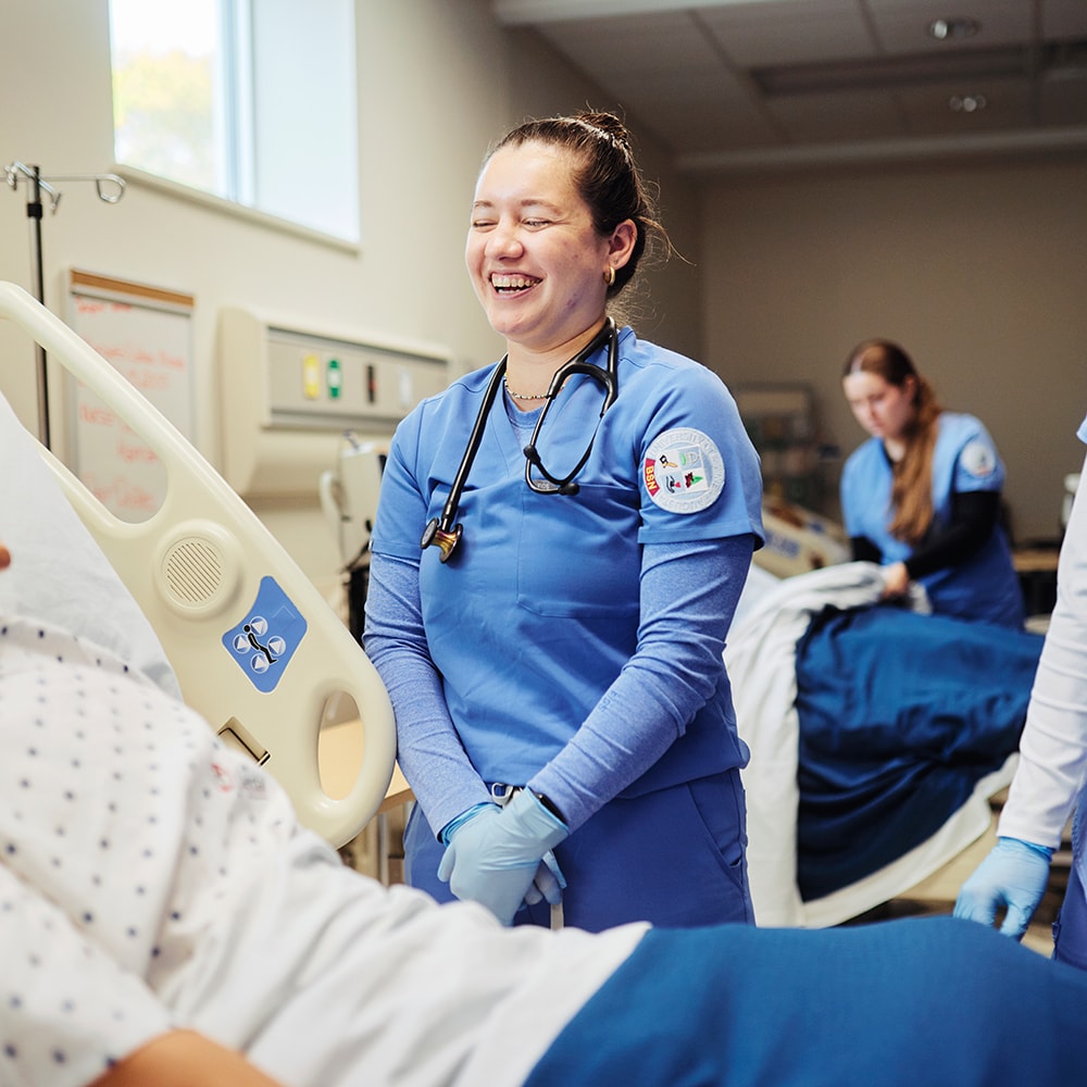 uma student smiling in sim lab