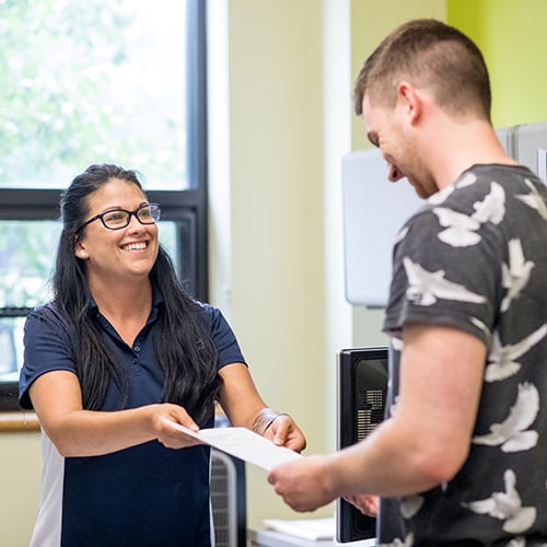 Admissions Counselor and Student in Admissions Office
