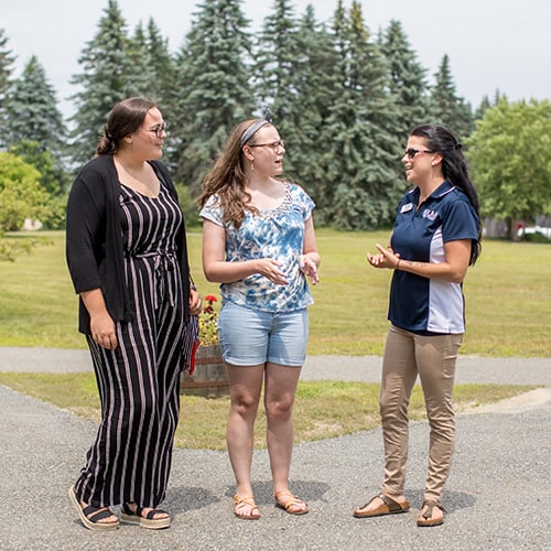 Admissions Counselor and Students on Campus
