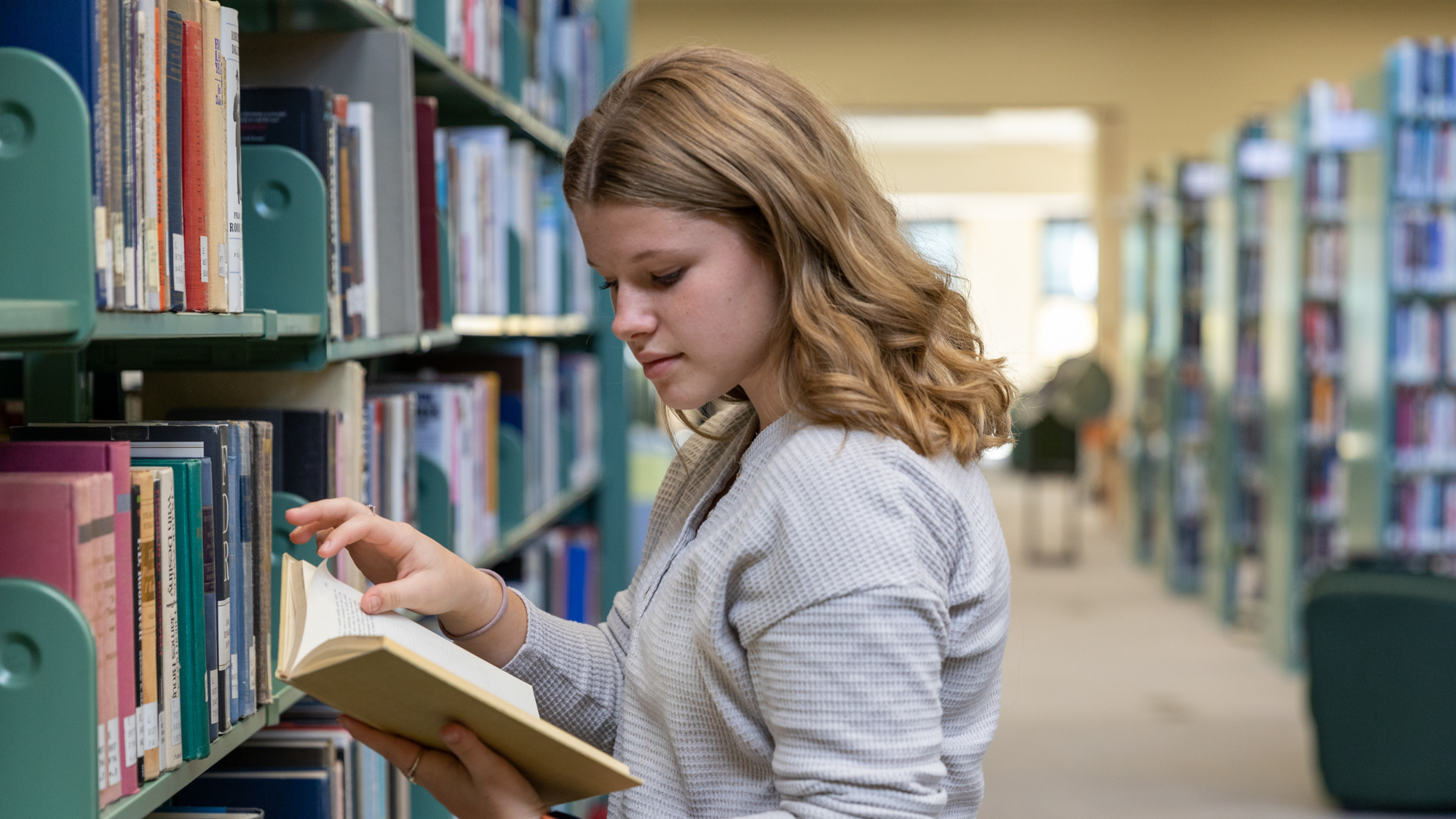 UMA Student peruses the library