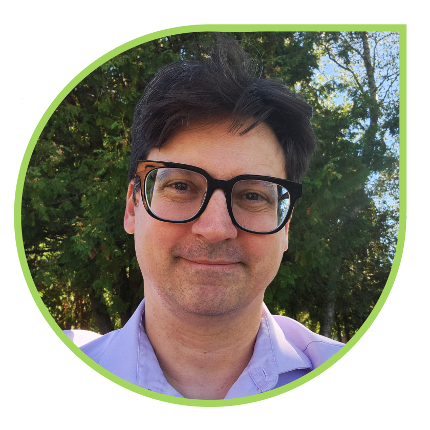 A profile photo of Chad Bouchard standing outdoors on the Bangor UMA campus. 