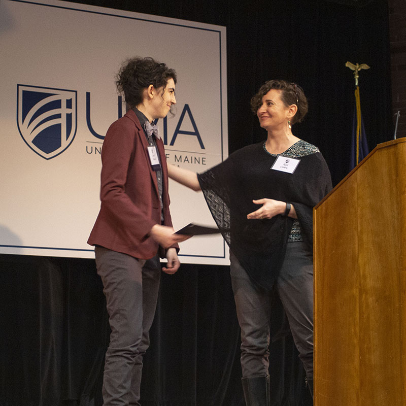 Sarah Nichols accepts an award from Prof. Corlew.