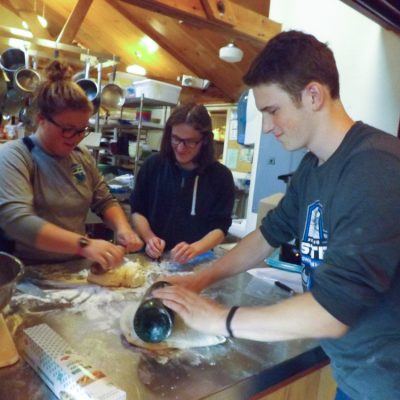 Participants rolling out bread dough fun at the French Immersion weekend.
