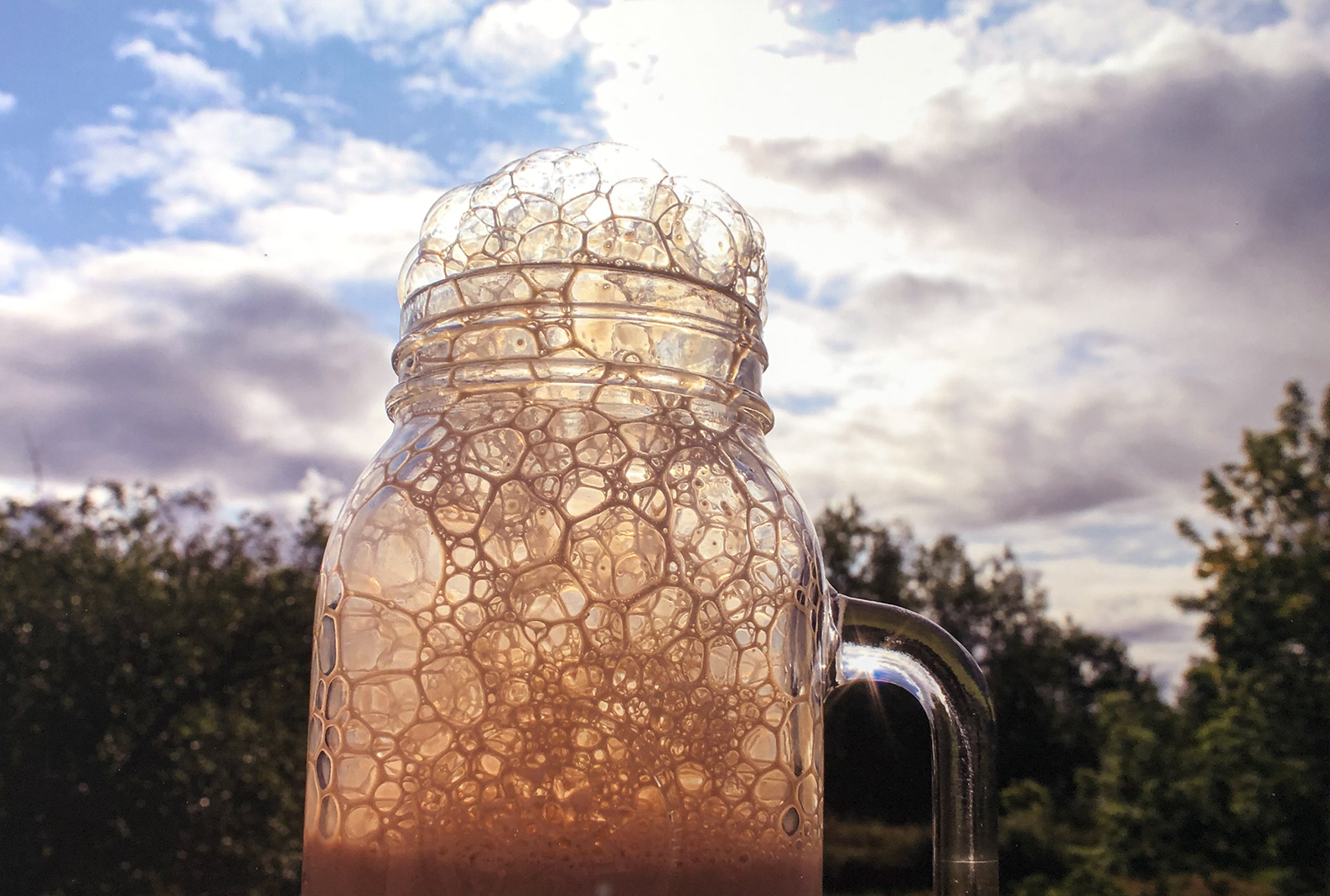 Photo of glass jar with liquid foaming through the top. Artist: Augrey Mclaughlin, "Bubbles", Cony High School