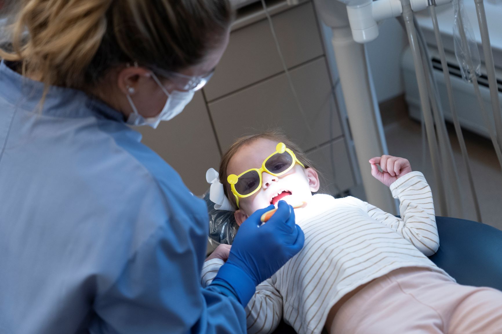 UMA Dental Assisting student cleans the teeth of a child.