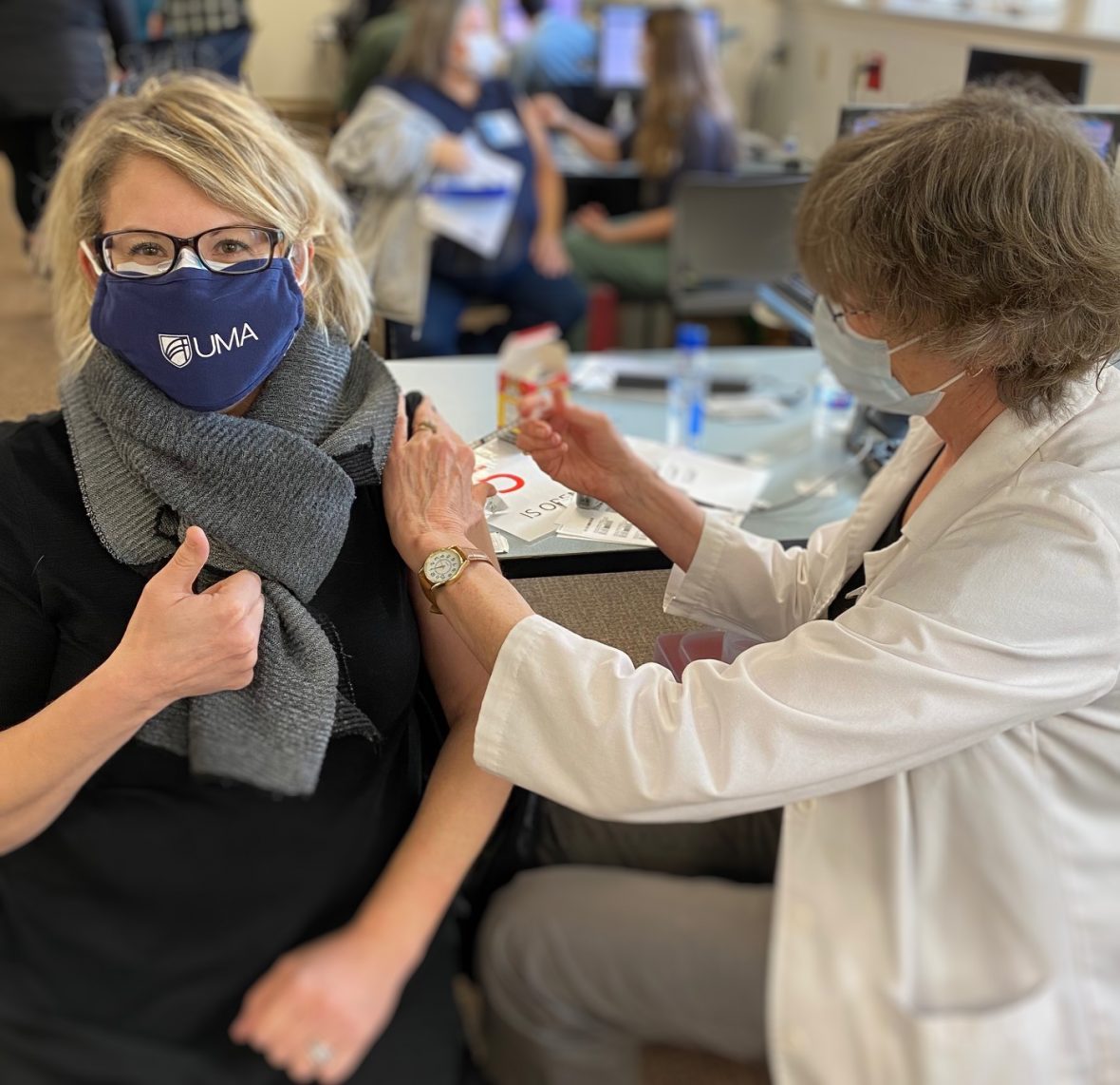 UMA Dental Health Programs Coordinator Nancy Foster, in UMA mask (photographed getting her injection in real time) received her first of two COVID-19 Vaccine.