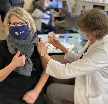 UMA Dental Health Programs Coordinator Nancy Foster, in UMA mask (photographed getting her injection in real time) received her first of two COVID-19 Vaccine.