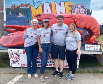 Althea Simeone, Renee Heal, Chip Curry, Katie Ebert at Maine Lobster Festival sign