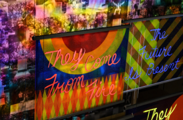 Colorful artwork and flags that states: "They come from fire/the future is present"