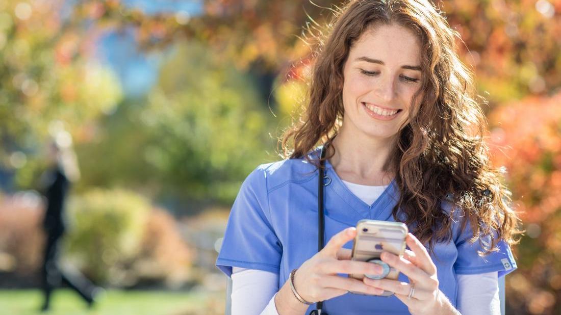 UMA nursing student using a smartphone