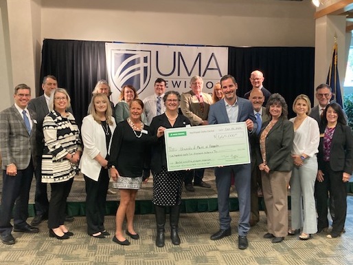 Group photo - NE Delta Dental presents large check to UMA administration and faculty members