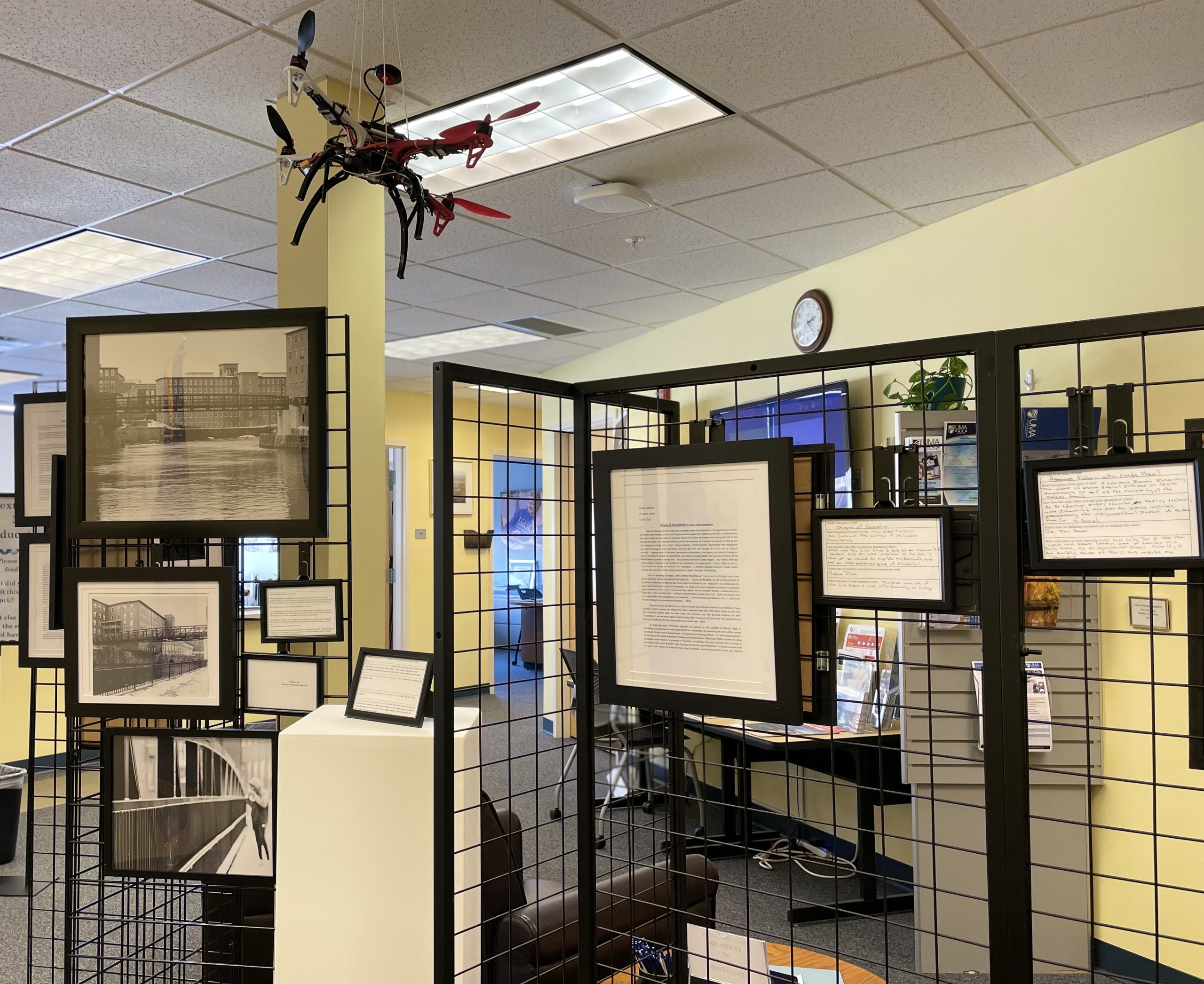 Various works by UMA Students. Our students come from across the USA. The display of student's work in black frames on a grid display.