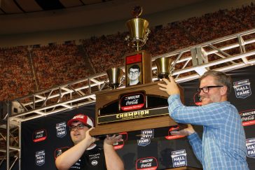 Parker White and Dale Earnhardt Jr. lift a huge trophy.