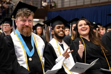 Happy graduates smile for the camera