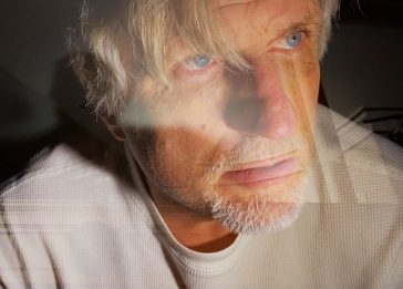 Al Kryszak in a dramatically lit portrait with layered visual effects.