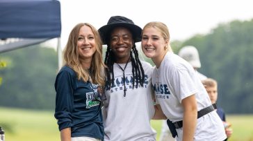Dean of Students Jen Davis with UMA students Bubbles and XX at the 2025 UMA Golf Tournament
