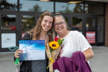 UMA Rising Scholar Sammi posts for a photo with her parent