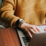 A woman typing on a laptop