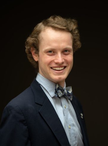 Dylan Sullivan headshot wearing a suit and bowtie