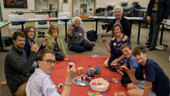 2024 French Immersion Weekend participants gathered at an indoor picnic