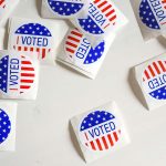 "I voted" stickers scattered on a table