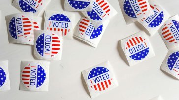 "I voted" stickers scattered on a table