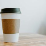 A to-go coffee cup on a wooden table
