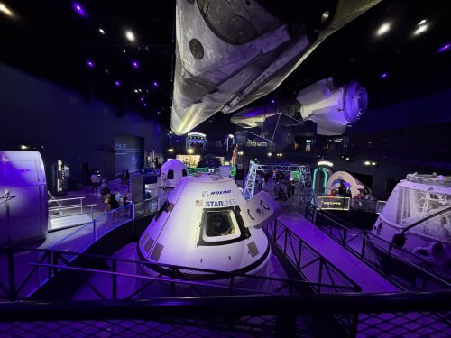an elevated perspective of an indoor space exhibit with purple lighting