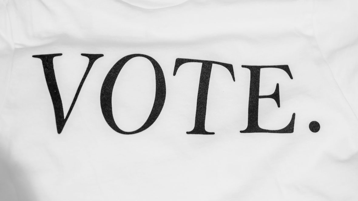 the word "VOTE" written on a t-shirt