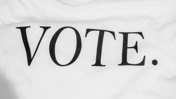 the word "VOTE" written on a t-shirt