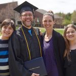 uma adult graduate and family