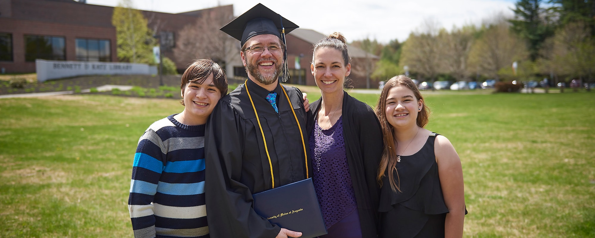 uma adult graduate and family