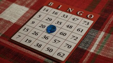 A bingo card with the free space covered by a blue marker