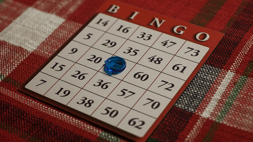 A bingo card with the free space covered by a blue marker
