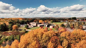 aerial drone still image of the UMA Augusta campus buildings surrounded by fall foliage