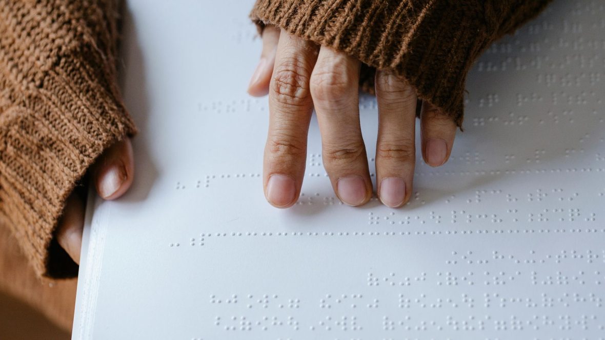 Hands reading braille