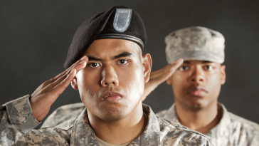 two servicemen saluting