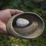 Hand holding a hand-woven basket